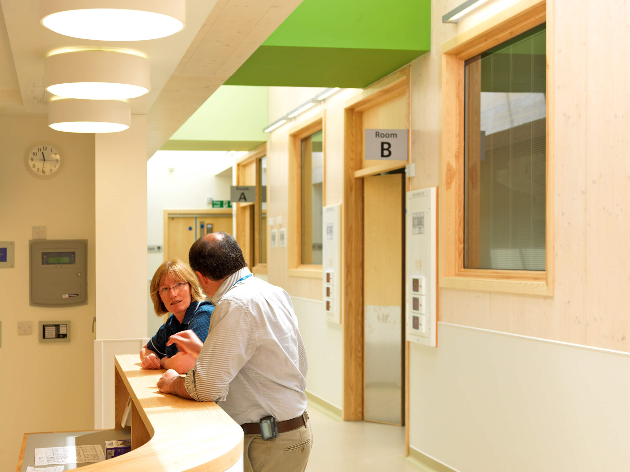 A doctor and nurse having a discussion at the nurse's station in the Dyson Centre for Neonatal Care at the Royal United Hospital in Bath.