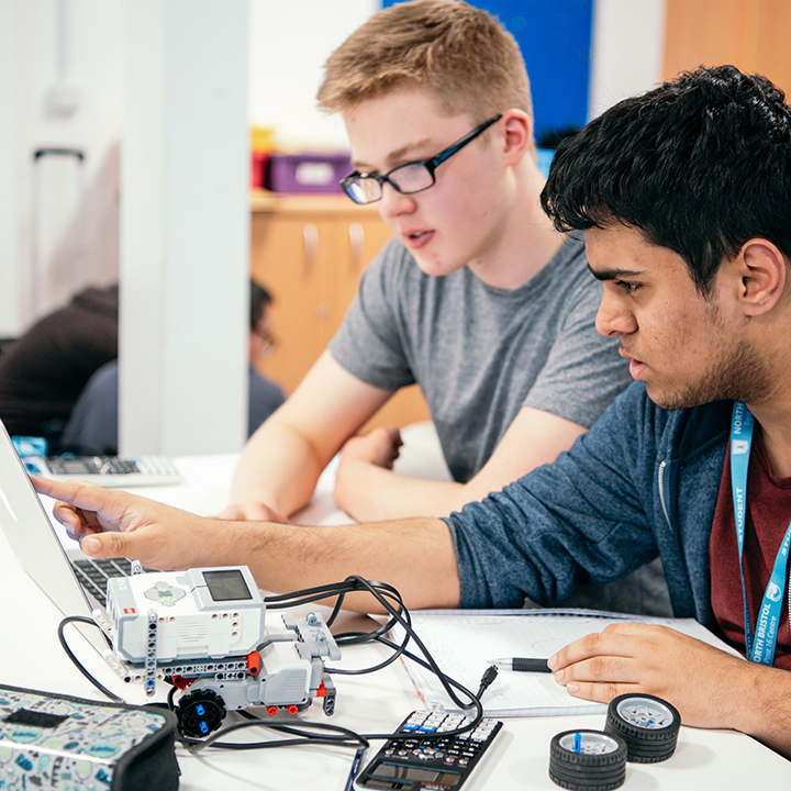 Two sixth form students programming a Lego Mindstorms robot in a James Dyson Foundation robotics workshop.