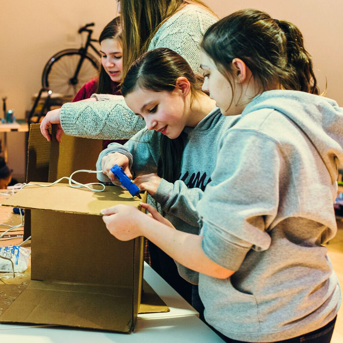 Female students working together to build a cardboard prototype