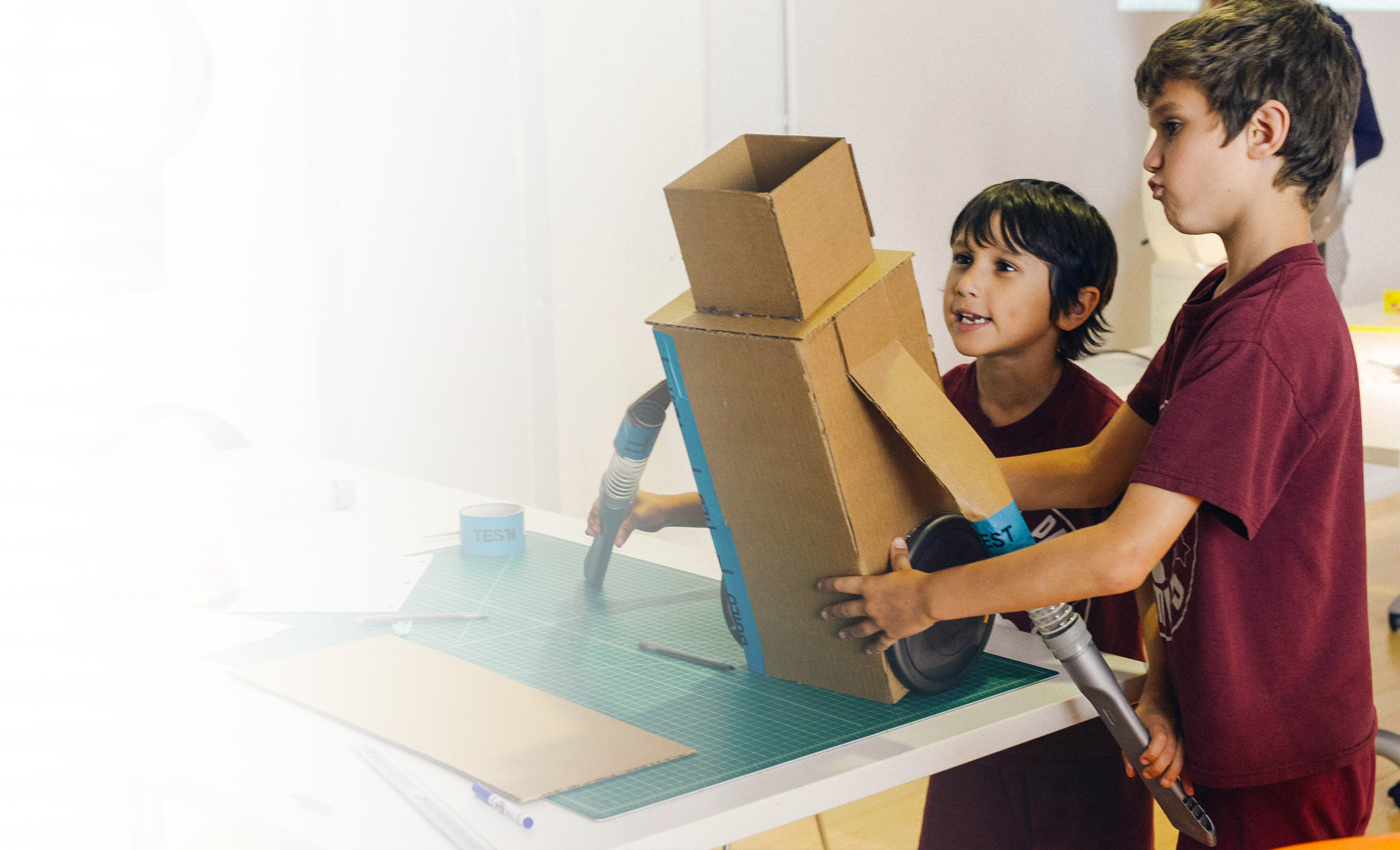 Two school students with their cardboard prototype.