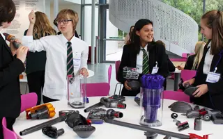 Students getting hands-on with excess Dyson machine parts to build prototypes.