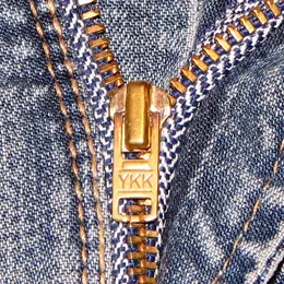 A close-up of a zip on denim.