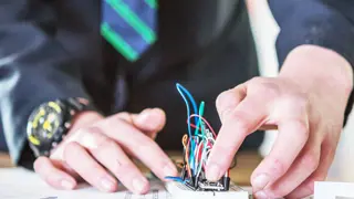 A student working on a circuit square.