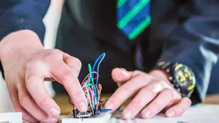 A student working on a circuit square.