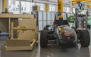 An F1 car (right) and early wooden model (left).
