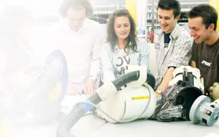 A team of engineers working on a prototype of a vacuum cleaner.