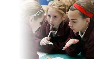 Three students discussing ideas for their prototype.