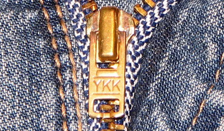 A close-up of a zip on denim.