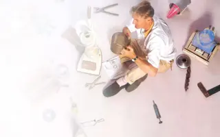 Sir James Dyson surrounded by prototyping materials as he builds his first vacuum, the DC01.