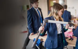 Two students working together to assemble a prototype.