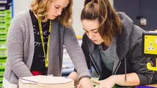 Two students assembling a prototype.