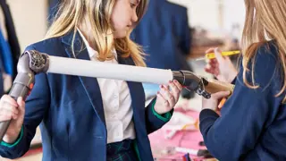 Two students working together to assemble a prototype.